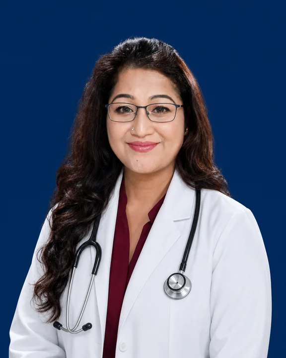 Dr. Priyanka Sachan wearing glasses and a stethoscope